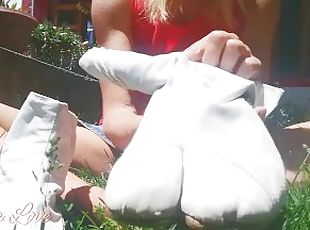 Girl puts on her white ninja shoes in the yard - Abella Love full video
