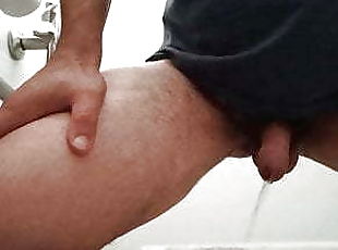 Pissing, fron view ina  public toilet