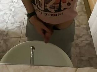 Pissing in a public toilet in the sink, filming through the mirror