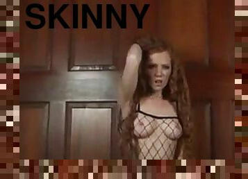 Skinny redhead in fishnets