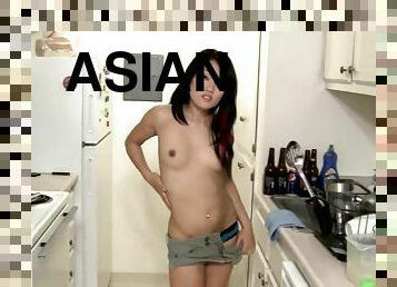 Asian babe is undressing in the kitchen