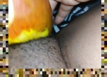 Massaging hairy pussy with fruit late night