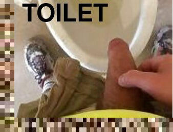 Construction worker pissing in the toilet