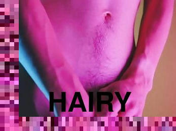 Sensual moves on colored background, showing bulge and hairy soft cock