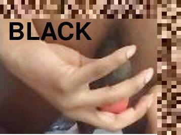 Black femboy Inserting butt plug