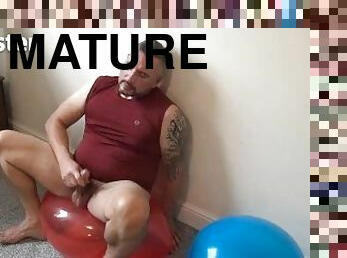 DILF blows up three balloons, pops one and cums on the other two PREVIEW