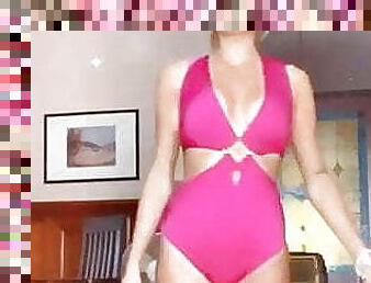 blonde girl in pink swimsuit does catwalk
