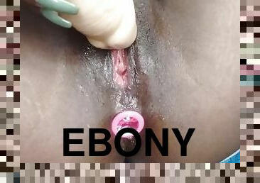 Ebony squirting with butt plug on