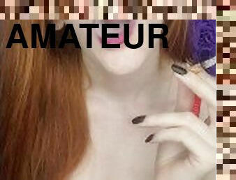 redhead beauty smokes a pink cigarette, purple makeup