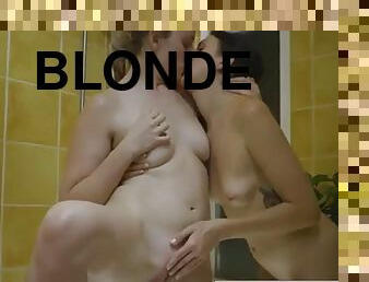 Blonde and brunette relax naked in the bathroom