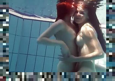 Mia and Petra undress each other in the pool