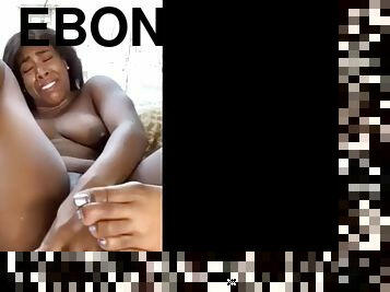 Ebony masturbates in front of a glass window on webcam