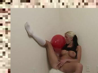 Tempting blonde with huge tits rubs pussy on balloon