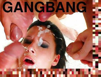 Dark-haired babe in a hardcore bukkake gangbang