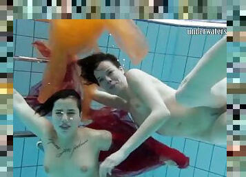 Two hotties submerged underwater