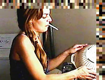 Cute chick smokes around the house