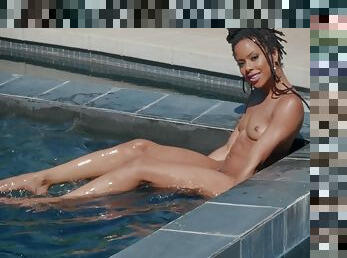 Ebony honey stands nude and reveals her slutty side by the pool