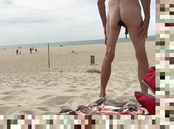 Dildo anal insertion on public beach