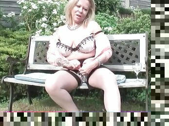 Mature unbuttons her cardigan and teases outdoors