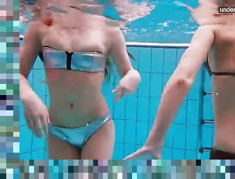 Three naked girls having fun underwater