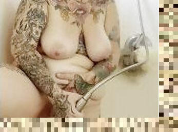 Tattooed BBW uses shower head to cum while husband works from home