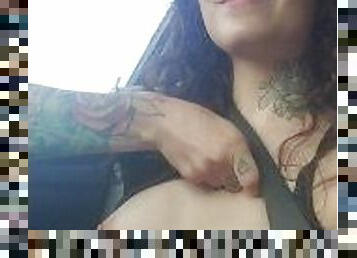 Cute Brunette with tattoos flashing her small boobs in a car