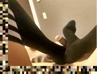 After the game footjob. Black thigh highs
